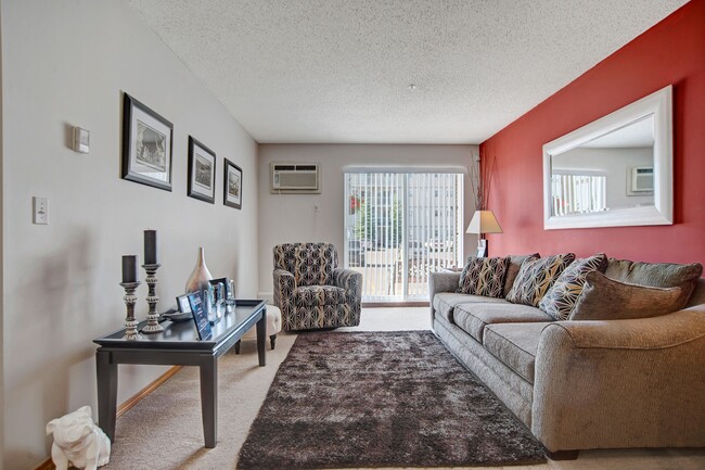 A living room with sliding glass doors and a red accent wall - Windsor Terrace