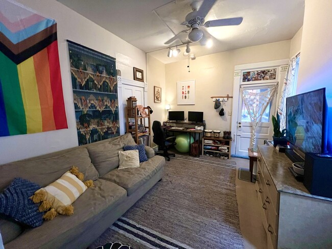 View from living room to front door/porch, including trac lights, closet + shelf space on the left. - 1321 Hunter Ave