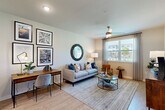 Located at 7001 Clementine Trl in Fairburn, Georgia, this thoughtfully designed one-bedroom, one-bathroom residence offers a comfortable and efficient single-floor layout. Light hardwood-style flooring flows throughout, creating a cohesive and airy feel.

The open-concept living and dining area is bright and welcoming, featuring a ceiling fan and a large window that invites natural light and outdoor views. The space comfortably accommodates both a seating area and a dedicated workspace.

The kitchen is a standout feature, boasting granite countertops, stainless steel appliances including a range, microwave, refrigerator, and dishwasher, along with a two-toned cabinetry design that pairs white upper cabinets with warm wood-toned lower cabinets. A generous island with bar seating serves as both a prep area and casual dining spot.

The bedroom is a serene retreat, featuring a ceiling fan, a large window with outdoor views, and a dedicated closet. The bathroom echoes the kitchen's design language with a granite-topped vanity, wood-toned cabinetry, and a large mirror. Clean, neutral tones throughout the home create a calm and modern ambiance ideal for everyday living.