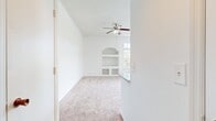 This 690 square foot apartment in Orlando, FL offers a blend of comfort and functionality in a compact space. The single-story layout comprises one bedroom, measuring 140 square feet, and one full bathroom. The heart of the home is an open-concept kitchen and living room area, promoting a sense of spaciousness and flow.

The apartment features plush wall-to-wall carpeting in the main living areas and bedroom, while the kitchen and bathroom boast durable wood-look flooring. Large windows, including a sliding glass door, flood the space with natural light and offer views of the surrounding landscape, enhancing the feeling of openness.

The kitchen is equipped with modern white cabinetry, granite countertops, and black appliances, including a refrigerator and range. A convenient in-unit laundry room with a washer and dryer set adds to the apartment's practicality.

The bedroom includes a ceiling fan for comfort and a built-in shelving nook, providing both character and storage. The bathroom features a white vanity with a granite countertop, matching the kitchen's aesthetic.

Additional amenities include ample closet space and central air conditioning. The apartment's neutral color palette and clean lines create a contemporary feel, offering a blank canvas for personalization. This efficient space is ideal for those seeking a low-maintenance lifestyle in a prime Orlando location.