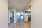 Located at 9 Gerviston Ct in Liverpool, NY, this one-bedroom, one-bathroom unit offers a well-organized, single-floor layout with a practical and comfortable design. A welcoming hallway connects the main living areas, featuring durable hardwood-style flooring that extends through the entryway, hallway, and kitchen. The kitchen is efficiently arranged in an L-shaped configuration with gray cabinetry offering ample upper and lower storage, a granite-style countertop, a double-basin sink, and white appliances including a range and refrigerator. The living room provides a generous, open feel with plush carpeting, a wall-mounted air conditioning unit, baseboard heating, and a sliding glass door that leads to a private balcony overlooking the surrounding neighborhood. The spacious bedroom includes soft carpeting, a closet with bi-fold doors, and direct access to the bathroom. An additional closet in the hallway adds further storage convenience. The full bathroom features a tub-shower combination with a curved curtain rod. Throughout the unit, neutral-toned walls, clean lines, and consistent finishes create a cohesive and functional living environment.