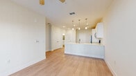 Located at 295 Royal Tern Cir in Rockledge, Florida, this well-appointed one-bedroom, one-bathroom residence offers a clean, modern aesthetic across a single thoughtfully designed floor. Light wood-style flooring runs consistently throughout, creating a cohesive and airy feel in every room.

The open-concept kitchen and living area serves as the heart of the home. The kitchen is outfitted with crisp white shaker-style cabinetry, generous storage including full-height pantry cabinets, stainless steel appliances — including a range, microwave, and dishwasher — and a white quartz peninsula with an undermount sink. A trio of pendant lights with brushed nickel hardware illuminate the workspace, complementing recessed lighting overhead.

The living area flows seamlessly from the kitchen, offering an open and versatile layout with a ceiling fan and access to natural light. The spacious primary bedroom features a ceiling fan, a closet, and windows fitted with blinds that frame views of the surrounding neighborhood. A private door leads to an outdoor area, adding a welcome connection to the exterior. The bathroom is clean and functional, with white cabinetry, a white countertop vanity, a large mirror, and light wood-tone flooring that mirrors the rest of the home. The overall ambiance is bright, neutral, and move-in ready.