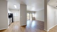 Located at 1456 E Pecos Rd in Gilbert, AZ, this well-appointed 2-bedroom, 2-bathroom single-floor residence offers a comfortable and functional layout. Wood-look flooring flows throughout the entire home, creating a cohesive and modern aesthetic. The open living area is bright and airy, benefiting from multiple windows and a sliding glass door that invites natural light and provides access to an outdoor area. A textured ceiling adds subtle character to the living space.

The kitchen is a standout feature, designed in a galley style with crisp white shaker cabinetry, stainless steel appliances including an electric range, microwave, dishwasher, and refrigerator, and a white quartz countertop. A pass-through breakfast bar connects the kitchen seamlessly to the living and dining area.

Both bedrooms are well-sized, with the primary bedroom offering generous proportions. Each bedroom features a ceiling fan, large windows with views of surrounding greenery, and ample natural light. One bedroom includes a built-in desk and cabinetry, ideal as a workspace. Two closets provide practical storage throughout the home.

The two bathrooms are clean and functional, each featuring a tub-shower combination, a vanity with storage, and light neutral finishes that complement the overall design of the home.