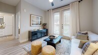 Located in Manor, TX, this well-designed one-bedroom, one-bathroom residence offers a thoughtful layout across a single floor. The open-concept kitchen and living area serves as the heart of the home, featuring crisp white shaker cabinetry, a subway tile backsplash, stainless steel appliances including a dishwasher, range, and refrigerator, and a peninsula with pendant lighting overhead. Light wood-look flooring runs throughout, lending warmth and visual continuity to every room. The living area is bright and welcoming, with floor-to-ceiling French doors that open to a private balcony, allowing natural light to pour in. The bedroom is a calm retreat, offering natural light through large windows with blinds and curtains, and connects directly to the full bathroom. The bathroom features white cabinetry, a single vanity with a under-mount sink, matte black hardware, and a shower-tub combination. Four closets provide exceptional storage throughout the unit. A clean entryway with light-toned walls and recessed lighting completes the layout. The overall palette is neutral and modern, creating a cohesive, comfortable living environment well-suited for everyday life.