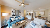 Located at 900 Legacy Park Dr in Lawrenceville, GA, this single-floor, three-bedroom, two-bathroom residence offers a well-designed layout with comfortable living spaces throughout. The open-concept living and dining area is anchored by warm hardwood-style flooring, crown molding, and a ceiling fan, with a sliding glass door that floods the space with natural light and provides access to an outdoor patio. An elegant arched passageway connects the living area to the rest of the home, adding a refined architectural touch.

The kitchen features white shaker cabinetry, white quartz-style countertops, a classic subway tile backsplash, and stainless steel appliances including a refrigerator, dishwasher, microwave, and range. The primary bedroom is a comfortable retreat with multiple windows, a ceiling fan, and access to a spacious walk-in closet outfitted with wire shelving and ample hanging space. Additional bedrooms also feature ceiling fans and generous natural light. The two bathrooms are finished with white vanities, large mirrors, and wood-look flooring. A dedicated in-unit laundry room with a full-size washer and dryer adds everyday convenience, completing this well-appointed Lawrenceville home.