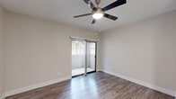 Located in Phoenix, AZ, this well-appointed one-bedroom, one-bathroom unit offers a thoughtfully designed layout that maximizes every square foot. The open-concept living and kitchen area serves as the heart of the home, where wood-style flooring flows seamlessly throughout. The kitchen stands out with crisp white shaker cabinetry, a classic subway tile backsplash, white quartz countertops, a breakfast bar peninsula, and a full suite of stainless steel appliances including a refrigerator, electric range, and built-in microwave. A skylight brightens the kitchen, adding a welcoming sense of openness.

The living area features a ceiling fan and a sliding glass door with vertical blinds that opens to a private outdoor patio, allowing natural light to fill the space. The bedroom is comfortably sized, appointed with its own ceiling fan, wood-style flooring, and a window with blinds that frames outdoor greenery. A dedicated closet provides ample storage. The bathroom includes a full tub-shower combination with chrome fixtures, complemented by neutral wall tones and wood-style flooring that tie the space together. Clean, light finishes and a neutral color palette throughout create a bright, move-in-ready environment.