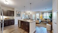 Located at 380 Mather St in Hamden, Connecticut, this one-bedroom, one-bathroom residence offers a thoughtfully designed single-floor layout that maximizes both comfort and functionality. Wood-style flooring flows throughout the space, lending warmth and visual continuity across every room.

The kitchen is a standout feature, boasting rich dark cabinetry, granite countertops, stainless steel appliances — including a gas range, microwave, refrigerator, and dishwasher — and a large island with pendant lighting and bar seating, making it ideal for both cooking and casual dining. The adjacent dining area provides a dedicated space for meals, while the open-concept living room is bright and welcoming, featuring soft sage-toned walls, large windows that invite natural light, floating wood shelves, and ample room for comfortable seating arrangements.

The bedroom is generously sized, appointed with soft, neutral tones, multiple windows with blinds and curtain panels, and hardwood-style flooring, creating a calm and restful retreat. The bathroom features a dark-toned vanity with a white countertop and clean, modern finishes. A hallway with crisp white panel doors provides access to additional storage. The overall ambiance is modern yet warm, with cohesive design choices throughout.