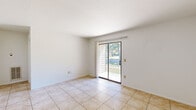 Located at 808 Charles Barker Ave in Cleveland, Texas, this single-story, one-bedroom, one-bathroom home offers a practical and functional layout across a compact yet efficient floor plan. The living room is bright and welcoming, featuring large-format tile flooring, a ceiling fan with light fixture, and a sliding glass door that fills the space with natural light while providing direct views of the surrounding greenery and outdoor area. The galley-style kitchen is well-equipped with warm wood cabinetry lining both walls, ample counter space, a double sink, a dishwasher, an electric range, and a refrigerator — offering strong storage and utility in a streamlined design. The bedroom is a comfortable, carpeted retreat with a ceiling fan, a closet, and a window that allows natural light to brighten the room. The full bathroom includes a tiled shower-tub combination with a grab bar, a toilet, and a vanity with cabinet storage beneath. Tile flooring continues throughout the kitchen and bathroom, providing a cohesive and easy-to-maintain finish. The clean white walls and neutral palette throughout the home create a bright, move-in-ready atmosphere suitable for a variety of lifestyles.