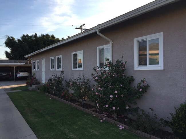 Side view of unit. Carport parking at rear of property. - 840 W 168th St