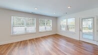Located at 5 Kathryn Way in Middleborough, MA, this thoughtfully designed 2-bedroom, 2-bathroom single-floor home offers a bright, modern living experience. The open-concept living room features warm hardwood flooring, recessed lighting, and large windows that invite generous natural light and outdoor views, creating an airy and welcoming atmosphere throughout.

The kitchen is well-appointed with white shaker-style cabinetry, white quartz countertops, stainless steel appliances including a refrigerator, electric range, and built-in microwave, and a stainless steel sink. A peninsula provides additional workspace and a natural transition into the living area.

The spacious primary bedroom is carpeted and filled with natural light from multiple windows, offering views of the surrounding neighborhood. It includes a dedicated closet with wire shelving for organized storage. The second bedroom, also carpeted, features a large window and clean white walls. Both bathrooms are finished with classic black-and-white mosaic tile flooring, white vanities with brushed hardware, and bright, clean fixtures. One bathroom includes a full soaking tub and shower combination with a large window for natural light. A second closet provides additional storage throughout the home.