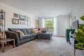 Located at 825 Jupiter Dr in Madison, WI, this well-appointed two-bedroom, two-bathroom unit offers a thoughtfully designed single-floor layout. The open-concept living and kitchen area forms the heart of the home, where a spacious carpeted living room receives generous natural light from a large window. The kitchen is a standout feature, boasting rich dark-wood cabinetry, granite countertops, stainless steel appliances including a refrigerator, range, and microwave, hardwood-style flooring, and a curved breakfast bar with pendant lighting overhead — ideal for casual dining or entertaining.

Both bedrooms are carpeted and comfortable, each equipped with a ceiling fan. The primary bedroom is generously sized with a window overlooking the greenery outside. The second bedroom offers a cozy and functional space as well. Six closets throughout the unit provide exceptional storage capacity. The two bathrooms include a clean, bright walk-in shower.

Additional highlights include an in-unit laundry area and a private patio with views of the surrounding landscaped community and mature trees. The overall ambiance is warm and functional, making this a practical and inviting place to call home in Madison.
