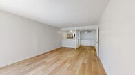 Located at 1340 N Poinsettia Pl, this single-floor, one-bedroom, three-bathroom unit offers a clean and functional layout designed for efficient everyday living. Throughout the space, light-toned hardwood flooring creates a warm and cohesive aesthetic, complemented by crisp white walls and textured ceilings.

The living room is an open, well-lit area that benefits from a large sliding glass door, which floods the space with natural light and provides direct access to an outdoor area with greenery views. A wall-mounted A/C unit ensures year-round comfort. Adjacent to the living room, a pass-through kitchen window connects the cooking area to the main living space, making the layout feel open and communicative. The kitchen is equipped with stainless steel appliances and overhead cabinetry.

The primary bedroom is generously proportioned, featuring a window with vertical blinds that allows natural light to enter. The room is finished with the same light hardwood flooring found throughout the unit and offers ample wall space for furnishing flexibility. A dedicated closet provides organized storage.

The three bathrooms are well-appointed with white cabinetry, clean countertops, and bright vanity lighting. At least one bathroom features a full soaking tub and toilet. Another showcases a wide vanity with mirrored storage and a sliding mirrored closet door, adding depth and functionality to the space.