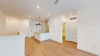 Located at 370 Homestead Ave in Greenwood, Indiana, this two-story home offers a clean, modern aesthetic with thoughtfully appointed spaces across two levels. The ground floor houses an attached garage with an automatic opener, built-in wall shelving, and an interior access door — providing both convenience and additional storage capacity.

The upper main living level is the heart of the home, featuring an open-concept kitchen and living area bathed in recessed lighting. The kitchen centers around a white shaker-style island with a dark countertop, complemented by pendant lighting in matte black and white cabinetry. Warm-toned luxury vinyl plank flooring runs throughout the main level, adding continuity and a welcoming feel.

The spacious primary bedroom features plush carpet, a ceiling fan with light, and two windows that invite natural light. It connects conveniently to the full bathroom and a dedicated closet. The bathroom is elegantly finished with marble-style tile surrounding the soaking tub and shower, a white vanity with gray countertop, and matching black hardware accents.

Additional highlights include a dedicated in-unit laundry area equipped with a full-size washer and dryer, and shaker-style interior doors with matte black hardware throughout, lending a cohesive, contemporary feel to the entire home.