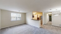 Located at 26 Cheswold Blvd in Newark, Delaware, this single-floor residence offers a practical and comfortable layout designed for everyday living. The open-concept living area is generously sized, featuring soft wall-to-wall carpeting and a large window that allows natural light to fill the space. A half-wall pass-through connects the living area to the kitchen, which is equipped with stainless steel appliances including an electric range, over-the-range microwave, dishwasher, and refrigerator. Contemporary white cabinetry and dark laminate countertops complete the kitchen's clean, functional aesthetic, complemented by wood-style flooring.

The residence includes multiple bedrooms, each carpeted and bright with natural light provided by windows fitted with blinds. Several bedrooms feature closet storage, and one bedroom benefits from a private en-suite bathroom. The bathrooms are finished with tile flooring; one includes a glass-enclosed walk-in shower, while the other features a tiled shower-tub combination. The neutral, warm color palette throughout the space creates a cohesive and inviting ambiance, making this residence a well-appointed and move-in-ready home.