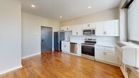 Located at 628 Madison Ave in Memphis, TN, this one-bedroom, one-bathroom unit offers a thoughtfully designed layout that maximizes every square foot. Rich hardwood floors flow throughout the space, complementing a clean, modern aesthetic.

The open-concept kitchen and living area is anchored by a well-appointed kitchen featuring white shaker cabinetry with matte black hardware, a full suite of stainless steel appliances—including a refrigerator, dishwasher, microwave, and range—and a single-basin sink beneath recessed lighting. The living area benefits from an accent wall of painted white exposed brick, large black-framed windows that invite abundant natural light, and serene outdoor views of surrounding greenery.

The bedroom is a comfortable retreat equipped with a ceiling fan, a large black-framed window, and built-in white wardrobe cabinetry offering generous storage. The bathroom is finished with neutral tile flooring, a white vanity with matte black fixtures, and a full tub-shower combination with clean white tile surround. A dedicated laundry area adds everyday convenience. The unit's blend of industrial character and modern finishes makes it a polished and functional living space in the heart of Memphis.