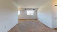 Located at 820 Carvel Dr in Dover, Delaware, this single-floor residence offers a straightforward and functional layout designed for comfortable everyday living. The interior features neutral-toned walls throughout, creating a clean and versatile backdrop suited to a variety of furnishing styles.

The living area is generously sized, with plush wall-to-wall carpeting underfoot and multiple windows that allow natural light to fill the space. The open feel of the room is enhanced by its simple, unobstructed layout and visible HVAC venting built into the ceiling.

The bedroom continues the carpeted aesthetic and includes a closet with louvered doors, providing practical storage. An adjacent doorway connects conveniently to the bathroom, adding to the ease of the floor plan.

The galley-style kitchen is efficiently arranged with cabinetry lining both sides, offering ample storage and counter space. White appliances, including a refrigerator and cooktop, are integrated into the layout, and tile flooring adds durability to the cooking area.

The bathroom features a full soaking tub with shower, tile wainscoting in a warm beige tone, and tile flooring that complements the clean, functional design of the space.

Overall, this residence presents a practical and well-organized single-level layout in a residential neighborhood in Dover, DE.