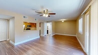 Located at 2 Hollandale in Clifton Park, NY, this well-appointed one-bedroom, one-bathroom residence offers a thoughtfully designed single-floor layout that maximizes both comfort and functionality. Rich hardwood flooring flows throughout the home, complementing the warm, neutral-toned walls found in every room.

The combined kitchen and living area forms the heart of the home. The living room is bright and airy, featuring a ceiling fan with light fixture, a large window, and a sliding glass door that opens to a private balcony with outdoor views. The kitchen is efficiently designed with warm wood cabinetry, a tile backsplash, and a full suite of stainless steel appliances including a refrigerator, range, microwave, and dishwasher. A pass-through window connects the kitchen to the living area, enhancing the open feel.

The spacious primary bedroom includes its own ceiling fan, a natural light-filled window, and generous proportions. The bathroom features tile flooring, a dark-toned vanity with a stone countertop, and a full tub-shower combination. A dedicated in-unit laundry area houses a full-size washer and dryer with overhead shelving. Four closets throughout the home provide exceptional storage, completing this practical and comfortable residence.