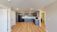 Located at 933 Lincoln Ave in Cincinnati's 45206 neighborhood, this single-floor, 2-bedroom, 1-bathroom residence offers a thoughtfully designed layout with modern finishes throughout. Light wood-tone flooring flows consistently across all rooms, creating a cohesive and clean aesthetic.

The kitchen is a standout feature, equipped with dark gray shaker-style cabinetry, light quartz countertops, and black appliances including a refrigerator, electric range, and dishwasher. Recessed lighting brightens the space, which opens to the rest of the home for a connected feel.

Both bedrooms are comfortable and well-lit, each featuring ceiling fans with light fixtures and windows with blinds that allow natural light to filter in. The primary bedroom includes a set of double closet doors for generous storage. The secondary bedroom also offers closet space with a built-in hanging rod.

The bathroom is finished with a dark vanity, white countertop, and brushed nickel grab bars, reflecting an accessible and practical design. A hallway connects the rooms efficiently, with a large double-door closet providing additional storage. The space also features central HVAC with ceiling vents throughout, ensuring year-round comfort.