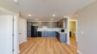 Located at 933 Lincoln Ave in Cincinnati's 45206 neighborhood, this single-floor, 2-bedroom, 1-bathroom residence offers a thoughtfully designed layout with modern finishes throughout. Light wood-tone flooring flows consistently across all rooms, creating a cohesive and clean aesthetic.

The kitchen is a standout feature, equipped with dark gray shaker-style cabinetry, light quartz countertops, and black appliances including a refrigerator, electric range, and dishwasher. Recessed lighting brightens the space, which opens to the rest of the home for a connected feel.

Both bedrooms are comfortable and well-lit, each featuring ceiling fans with light fixtures and windows with blinds that allow natural light to filter in. The primary bedroom includes a set of double closet doors for generous storage. The secondary bedroom also offers closet space with a built-in hanging rod.

The bathroom is finished with a dark vanity, white countertop, and brushed nickel grab bars, reflecting an accessible and practical design. A hallway connects the rooms efficiently, with a large double-door closet providing additional storage. The space also features central HVAC with ceiling vents throughout, ensuring year-round comfort.
