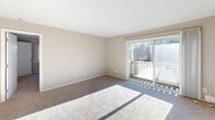 Located at 60 Sandy Ln in Warwick, Rhode Island, this one-bedroom, one-bathroom residence offers a practical and comfortable single-floor layout. The living room is bright and open, featuring soft carpeting, neutral-toned walls, and a sliding glass door that leads to a private balcony with views of surrounding natural foliage, allowing generous natural light to fill the space. Adjacent to the living area is a dedicated dining room, providing a clear separation between entertaining and relaxation areas. The kitchen is equipped with warm-toned wooden cabinetry extending to the ceiling for maximum storage, a stainless steel refrigerator, and a gas range, all set on easy-to-maintain wood-style flooring. The spacious bedroom offers carpeted floors, a large window with outdoor views, and baseboard heating for year-round comfort. Two closets provide ample storage, one of which is a walk-in style fitted with dual hanging rods and shelving. The full bathroom features a white vanity with a stone-style countertop, wood-look flooring, and a tub-shower combination. Throughout the residence, a consistent neutral color palette and baseboard heating system create a clean, cohesive, and comfortable living environment.