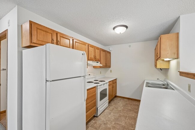 Step into the inviting kitchen of Mill Pond Apartments, where ample storage meets a bright, functional space. Imagine culinary creations in this well-appointed area, designed for your comfort and convenience. Schedule your tour today! - Mill Pond Apartments
