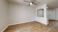 Located at 4630 S Lakeshore Dr in Tempe, Arizona, this 2-bedroom, 1-bathroom residence offers a well-organized single-floor layout designed for comfortable living. Wood-look flooring runs consistently throughout the home, creating a warm and cohesive aesthetic.

The open living room serves as the centerpiece of the home, featuring a classic fireplace with a white tile surround, built-in shelving for display or storage, and a charming arched pass-through that frames the space architecturally. A sliding glass door invites natural light and provides outdoor access. A decorative half-wall with an arched niche adds a distinctive design element that connects the living area to the rest of the home.

The U-shaped kitchen is efficiently laid out with grey shaker-style cabinetry, white countertops, and a full suite of stainless steel appliances including a refrigerator, range, microwave, and dishwasher. A window above the sink brings in natural light. An arched hallway leads from the kitchen through to the bedrooms.

The spacious primary bedroom includes a ceiling fan, crown molding, and a walk-in closet with wire shelving. The second bedroom also features a ceiling fan and a window with natural light. The bathroom is clean and functional, offering a grey vanity with a white countertop and wood-look flooring. A dedicated walk-in closet with multi-level wire shelving provides generous storage.