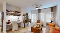 Located at 13030 Perry Road in Houston, TX 77070, this 1-bedroom, 1-bathroom residence offers a smartly designed single-floor layout that maximizes every square foot. The bright and open living room features light wood-style flooring, a ceiling fan, and large windows with blinds that invite an abundance of natural light. A built-in granite desk with wall-mounted shelving provides a dedicated workspace, while a sliding glass door offers direct outdoor access. The kitchen is a standout, showcasing granite countertops, white shaker cabinetry, a herringbone tile backsplash, stainless steel appliances, and a peninsula with pendant lighting and bar seating — ideal for casual dining. The bedroom is a comfortable retreat, complete with a ceiling fan, plush carpeting, natural light from a large window, and direct access to the bathroom. The bathroom features granite countertops, white cabinetry, a large vanity mirror, and a marble-style tiled tub surround. A dedicated laundry room houses a full-size washer and dryer with overhead shelving for added storage. A walk-in closet completes the unit. The overall design presents a clean, contemporary aesthetic with a warm and inviting ambiance throughout.