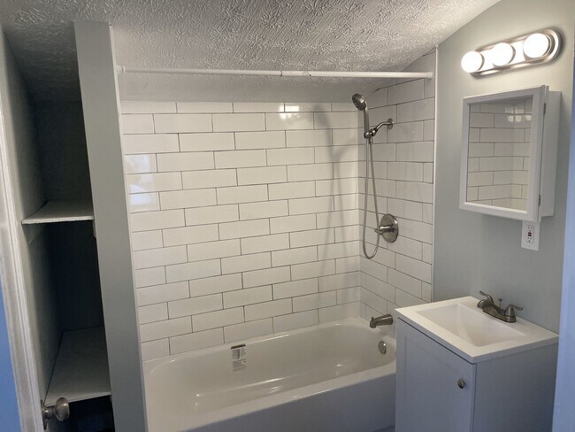 Updated bath with subway tiles and new tub/vanity/toilet - 30132 Robert St
