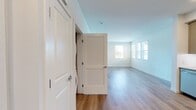 Located at 30950 Hanover Ln, Unit 14-103 in Menifee, CA, this 670-square-foot, single-story, 1-bedroom, 1-bathroom apartment is thoughtfully designed with a clean, modern aesthetic. The open-concept living and kitchen area features light wood-look vinyl flooring and crisp white walls that maximize brightness. Multiple windows fitted with horizontal blinds allow natural light to pour in, offering views of the surrounding greenery. The kitchen is well-appointed with taupe shaker-style cabinetry, white subway tile backsplash, recessed lighting, and a full suite of stainless steel appliances including a gas range, over-the-range microwave, dishwasher, and a large side-by-side refrigerator. The living room provides ample space and includes a private entry door with direct outdoor access. The 140-square-foot bedroom features plush carpet flooring, a window with natural light, and direct access to a walk-in closet outfitted with dual wire shelving systems for generous storage. The bathroom offers a full tub-shower combination with tiled surround, wood-look flooring, and clean white finishes throughout. In-unit laundry connections are also present, adding everyday convenience to this well-designed Menifee residence.
