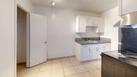 Located at 889 Riverside Dr in Fort Lauderdale, FL, this single-story, one-bedroom, one-bathroom home offers a practical and comfortable layout. Light-toned ceramic tile flooring runs throughout the entire space, lending a clean, cohesive look that is well-suited to the South Florida climate.

The combined dining and living area is bright and open, featuring a ceiling fan with light fixture and a window that invites natural light. The galley-style kitchen is efficiently designed with crisp white cabinetry, granite countertops, a stainless steel sink, and black appliances including a range and refrigerator — maximizing function within a compact footprint.

The bedroom is a generously sized retreat, complete with its own ceiling fan, a window with outdoor views of greenery, and direct access to three closets, providing excellent storage capacity. The bathroom is well-appointed with a full tub-shower combination, accented by classic tile surround in warm neutral tones.

Textured ceilings are consistent throughout the home. The clean white walls create a bright, airy ambiance across every room. With its straightforward layout and practical finishes, this Fort Lauderdale home offers a comfortable and low-maintenance living environment.