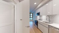 Located at 1641 Lincoln Blvd in Santa Monica, CA, this 390-square-foot, one-bedroom, one-bathroom apartment offers a modern and efficiently designed living space. The unit features light bamboo hardwood flooring throughout, recessed lighting, and a clean, neutral color palette that enhances the sense of space.

The galley-style kitchen is well-appointed with high-gloss flat-panel cabinetry, a marble-look quartz backsplash and countertops, and a full suite of stainless steel appliances including a range, microwave, dishwasher, and refrigerator. The kitchen flows into the main living area, which is bright and open with large, black-framed windows that bring in natural light and outdoor views.

The primary bedroom measures 120 square feet and includes a ceiling fan, double-door closet, and continued bamboo flooring. The bathroom is finished with large-format marble-look tile flooring, a soaking tub with shower combination, brushed gold fixtures, and a multi-bar towel rack, delivering a clean and contemporary aesthetic. The unit also features a keypad-secured entry door for added convenience and security. This compact, modern residence is ideal for those seeking functional urban living in the heart of Santa Monica.