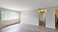 Located at 20 Eastview Dr in Watervliet, NY, this single-floor unit offers a well-organized layout with a clean, neutral aesthetic throughout. The living room is bright and open, finished with light-toned luxury vinyl plank flooring and featuring large vertical-blind windows that allow generous natural light and views of the surrounding greenery. A wall-mounted AC unit and baseboard heating provide year-round climate control.

The kitchen has been updated with white cabinetry, granite-style countertops, a black electric range with overhead ventilation, and matching vinyl plank flooring, creating a functional and modern cooking space.

The bedrooms are carpeted and offer comfortable proportions, each with windows overlooking the outdoors and baseboard heating. One bedroom includes a ceiling fan, a spacious walk-in closet with sliding doors, and an additional access door, adding notable utility to the space.

The bathroom is clean and straightforward, featuring a full tub-shower combination with a white surround, wood-toned flooring, and standard fixtures. A hallway connects the rooms efficiently, maintaining a logical and accessible flow through the unit. Overall, the space presents a practical, well-maintained environment with updated finishes and consistent natural light.