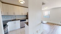 Located at 7411 Yonge Street in Markham, Ontario, this well-laid-out two-bedroom, one-bathroom unit offers a clean, modern aesthetic throughout. Light-toned hardwood flooring runs across the main living areas and bedrooms, lending warmth and continuity to the space.

The open living room is bright and airy, featuring crisp white walls and a large sliding glass door that floods the room with natural light and frames views of the surrounding neighbourhood. The adjacent dining area connects seamlessly to the kitchen, which is outfitted with white shaker-style cabinetry, dark countertops, a subway tile backsplash, and stainless steel appliances including a refrigerator, stove, and dishwasher. Tile flooring in the kitchen provides a practical transition from the rest of the unit.

Both bedrooms are comfortably sized, each featuring large windows that bring in ample daylight and offer neighbourhood views, along with baseboard heating for year-round comfort. The primary bedroom provides a generous footprint suitable for a full bedroom suite.

The bathroom is finished with floor-to-ceiling neutral tile, a full soaker tub with an overhead shower, and chrome fixtures, offering a clean and functional design. Overall, the unit presents a bright, move-in ready living space in a convenient Markham location.