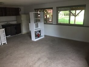 living room with view to back yard - Gilcrest Apartments - Utilities Included
