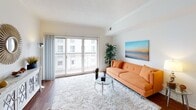 This single-floor residence offers a thoughtfully designed layout that balances comfort and functionality. The bright living room serves as the heart of the space, featuring rich hardwood flooring, a large sliding glass door that opens to a private balcony, and abundant natural light that fills the room throughout the day. A plush area rug and glass coffee table complement the welcoming atmosphere.

The kitchen is well-equipped with warm maple cabinetry, granite countertops, and stainless steel appliances including a refrigerator, range, and microwave. A peninsula with bar seating provides a casual dining option and connects the kitchen seamlessly to the living and dining areas, enhancing the open-concept flow of the space.

The bedroom is a serene retreat with soft carpeting, a walk-in closet offering generous storage, and a sliding door with vertical blinds that allows for natural light and outdoor access. A full bathroom features tile flooring, a granite vanity with ample counter space, and a full-sized tub and shower combination.

Throughout the residence, neutral tones, clean lines, and consistent finishes create a cohesive and inviting aesthetic, making this a comfortable and practical living space.