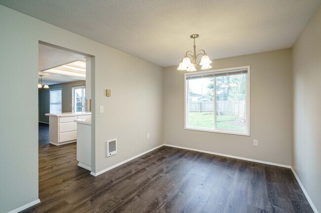 Building Photo - Recently Updated with Wood Laminate Flooring and Fresh Paint