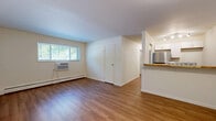Located at 3623 Clarion Ave in Cincinnati, OH, this two-bedroom, one-bathroom unit offers a well-organized single-floor layout designed for comfortable everyday living. Warm-toned hardwood-style flooring runs throughout the entire space, creating a cohesive and inviting atmosphere from room to room.

The living room is an open, light-filled area anchored by a wide window that brings in natural light and outdoor greenery views. A window AC unit and baseboard heating provide year-round climate control. The space flows seamlessly into a kitchen area featuring a breakfast bar counter, white cabinetry, track lighting, and a stainless steel refrigerator.

Both bedrooms are well-proportioned, each equipped with ceiling fans and baseboard heating. The primary bedroom is a comfortable size and includes access to a dedicated closet. Windows in each bedroom allow for natural light and ventilation. A bold blue entry door adds a distinctive touch to the foyer area, which features clean white walls and a flush ceiling light.

The bathroom is clean and functional, featuring a full tub-shower combo with white tile surround, chrome fixtures, and built-in shelving. Throughout the unit, the crisp white walls and light flooring create a bright, neutral palette ready for personalization.