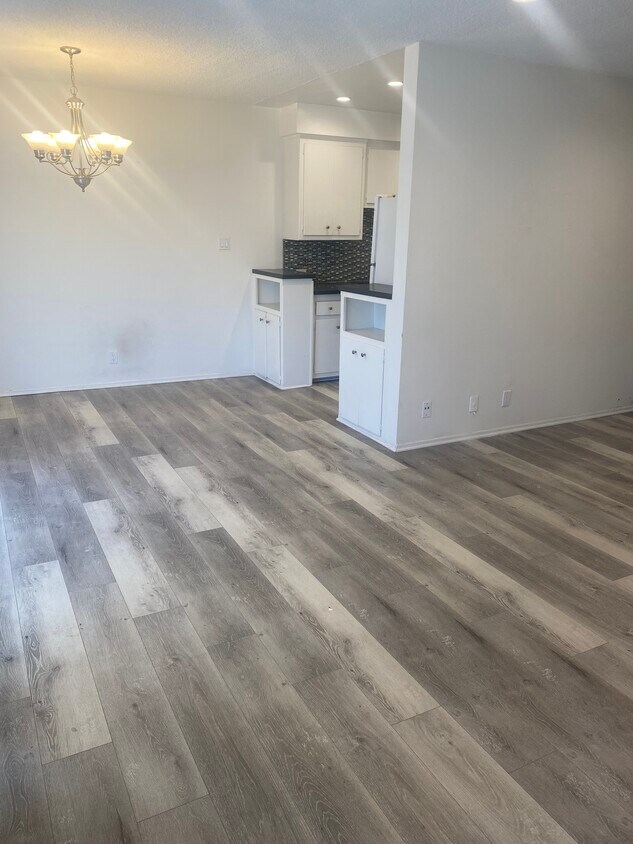Walking into the apartment, to the left is the dining area to the right is the living room - 906 N Orange Grove Ave