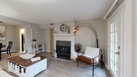 Located at 308 Plus Park Blvd in Nashville, TN, this single-story, three-bedroom, one-bathroom home offers a well-organized layout with a comfortable and cohesive design throughout. The living room serves as the heart of the home, featuring light wood-style flooring, neutral gray walls, a textured ceiling, and a standout wood-burning fireplace with a white mantel. French doors lead from the living area to the outside, filling the space with natural light and providing an airy, open feel. Adjacent to the living room, the dedicated dining area is a functional and inviting space with wood-style flooring and a ceiling fan overhead. The galley-style kitchen is efficiently designed with white cabinetry, dark countertops, a double stainless steel sink, and black appliances, with a pass-through view into the dining area. The primary bedroom offers carpeted flooring and a window that brings in natural light. The additional bedrooms are also carpeted and offer comfortable, versatile spaces. The full bathroom features white cabinetry, dark countertops, a vanity mirror, and a tub with shower. A closet provides added storage convenience. The home's consistent neutral palette and wood-style flooring tie each room together cohesively.