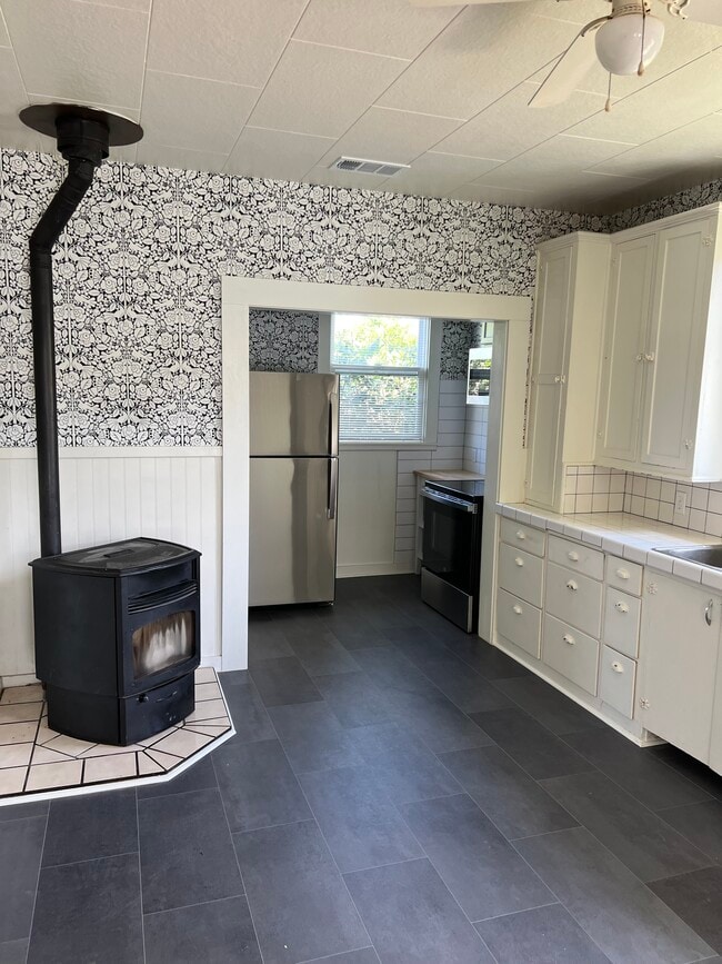 Kitchen with pellet heat stove - 557 Washington St