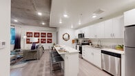 Located at 947 N Park Ave in Tucson, Arizona, this thoughtfully designed one-bedroom, one-bathroom unit offers a efficient and modern living experience across a single floor. The open-concept layout seamlessly connects the kitchen and living area, creating a bright and functional space.

The kitchen is a standout feature, showcasing crisp white cabinetry, stone-look countertops, and a full suite of stainless steel appliances including a range, over-the-range microwave, dishwasher, and refrigerator. A central island with seating provides additional prep space and serves as a casual dining area. Recessed lighting and light wood-style flooring add to the clean, contemporary aesthetic, while an exposed concrete ceiling element introduces an industrial design touch.

The bedroom offers a comfortable and cozy retreat, featuring the same exposed concrete ceiling detail and a window that invites natural light. A dedicated desk area within the room makes it well-suited for remote work or study.

The bathroom is finished with a white vanity topped with a speckled stone countertop, light wood-style flooring, and clean, neutral walls, creating a calm and functional space.

Throughout the unit, the consistent use of light tones, modern finishes, and clean lines establishes a cohesive, contemporary atmosphere ideal for Tucson urban living.