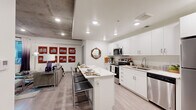 Located at 947 N Park Ave in Tucson, Arizona, this thoughtfully designed one-bedroom, one-bathroom unit offers a efficient and modern living experience across a single floor. The open-concept layout seamlessly connects the kitchen and living area, creating a bright and functional space.

The kitchen is a standout feature, showcasing crisp white cabinetry, stone-look countertops, and a full suite of stainless steel appliances including a range, over-the-range microwave, dishwasher, and refrigerator. A central island with seating provides additional prep space and serves as a casual dining area. Recessed lighting and light wood-style flooring add to the clean, contemporary aesthetic, while an exposed concrete ceiling element introduces an industrial design touch.

The bedroom offers a comfortable and cozy retreat, featuring the same exposed concrete ceiling detail and a window that invites natural light. A dedicated desk area within the room makes it well-suited for remote work or study.

The bathroom is finished with a white vanity topped with a speckled stone countertop, light wood-style flooring, and clean, neutral walls, creating a calm and functional space.

Throughout the unit, the consistent use of light tones, modern finishes, and clean lines establishes a cohesive, contemporary atmosphere ideal for Tucson urban living.