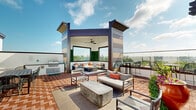 Located at 9015 Eager Rd in Richmond Heights, MO, this rooftop terrace offers an expansive open-air retreat with a well-designed layout suited for both relaxation and entertainment. The herringbone-patterned brick flooring spans the entire level, lending a classic yet contemporary aesthetic throughout the space.

A central covered pavilion serves as the focal point, featuring a ceiling fan, built-in bench seating with cushions and accent pillows, and a living wall of lush greenery. Adjacent to the pavilion, an outdoor kitchen station is equipped with a stainless steel gas grill, providing a dedicated area for outdoor cooking and gatherings.

Multiple seating zones are distributed across the terrace, including a casual lounge area with modern upholstered chairs and a concrete coffee table, a dining table with wire-frame chairs, and a pergola-shaded section outfitted with a mounted flat-screen television and additional dining seating — ideal for group events or screenings.

Glass perimeter railings line the edges of the terrace, preserving unobstructed panoramic views of the St. Louis skyline, surrounding treetops, and the broader Richmond Heights neighborhood. High-top bistro tables and bar-height chairs are positioned along the railing to take full advantage of these sweeping vistas. Potted greenery adds natural accents throughout, enhancing the outdoor ambiance of this versatile rooftop space.