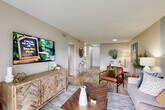 Located at 4581 South Kirkman Road in Orlando, Florida, this thoughtfully designed one-bedroom, one-bathroom residence offers a comfortable and functional layout across a single floor. Light wood-look flooring flows throughout the space, lending a clean, cohesive aesthetic from room to room.

The entrance leads into a hallway that opens to a spacious combined living and dining area. The living room features a neutral color palette accented by a bold blue feature wall, creating a modern focal point. Natural light filters in through sliding glass doors that connect to a private balcony, enhancing the sense of openness.

The kitchen is outfitted with crisp white shaker cabinets, granite countertops, stainless steel appliances, and ample storage — a practical and attractive workspace. Five closets are distributed throughout the unit, offering exceptional storage capacity.

The bedroom is generously sized, highlighted by a striking blue accent wall, textured ceiling, and a window with natural light. The full bathroom features granite countertops, white cabinetry, and a tub-shower combination. A dedicated utility room and hallway round out the floor plan. This residence combines modern finishes with a well-organized layout, making efficient use of every square foot.