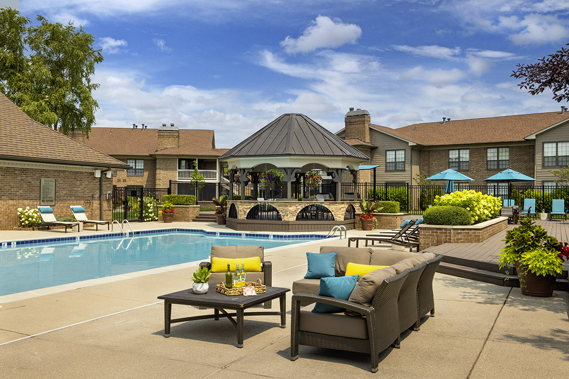 Piscina inspirada en el centro vacacional con sillones - Willow Lake Apartments