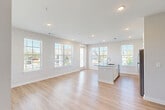 Located at 380 Exchange Blvd in Winder, Georgia, this single-floor, 2-bedroom, 2-bathroom residence offers a clean, modern aesthetic with thoughtfully selected finishes throughout. The open-concept kitchen and living area serves as the heart of the home, where light hardwood-style flooring flows seamlessly underfoot. The kitchen is outfitted with crisp white cabinetry extending to the ceiling, a white tile backsplash, stainless steel appliances including a refrigerator, range, and microwave, and a granite-topped island with an integrated sink — providing both functionality and a central gathering point. The adjacent living area is bright and airy, with multiple windows dressed in white blinds that invite natural light and outdoor views.

Both bedrooms feature neutral carpet, ceiling fans, and generously sized windows that continue the theme of natural light. The two bathrooms are finished consistently, each featuring granite-topped white vanities and light wood-style flooring. One bathroom includes a tiled soaking tub and shower combination. Throughout the unit, neutral gray-white walls, clean white trim, and recessed lighting contribute to a cohesive, contemporary atmosphere that is both inviting and move-in ready.