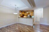 Located at 2285 Metropolitan Pkwy SW in Atlanta, GA, this well-appointed single-floor residence offers three bedrooms and three full bathrooms across a comfortable and efficiently designed layout. The open-concept kitchen and living area serves as the heart of the home, showcasing rich hardwood flooring, crown molding, and elegant wainscoting details. The kitchen is equipped with stainless steel appliances — including a refrigerator, range, and microwave — complemented by warm maple cabinetry, granite countertops, a tile backsplash, a built-in wine rack, and a breakfast bar with pendant lighting. A tray ceiling adds architectural interest to the dining area. The primary bedroom features a ceiling fan, a bay window that invites natural light, and a tray ceiling with crown molding. Its en-suite bathroom includes a double vanity with granite countertops, a soaking tub, and tile flooring. The additional bedrooms offer hardwood floors and generous proportions. A dedicated laundry room houses a full-size top-load washer and dryer. Throughout the home, crown molding, neutral tones, and consistent finishes create a cohesive and polished ambiance.