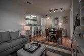 Located along East Lakeshore Drive in Lake Elsinore, California, this single-story home offers a cohesive coastal-inspired design throughout its well-planned layout. Warm hardwood flooring flows continuously across all living areas, creating a unified and inviting atmosphere.

The open-concept kitchen is outfitted with white cabinetry, dark stone countertops, a double-basin sink, and white appliances including a gas range and dishwasher. A peninsula with a breakfast bar connects the kitchen to the adjacent living and dining areas, making it well-suited for both everyday living and entertaining.

The living room is bright and airy, featuring large windows with blinds that allow natural light to fill the space, along with a ceiling fan overhead. The room's nautical-themed décor adds a relaxed, lakeside character.

Two bedrooms provide comfortable accommodations, each featuring hardwood floors, ceiling fans, natural light from windows with blinds, and ample room for furnishings. The bathroom is well-equipped with white cabinetry, a wide vanity with a large mirror, stone-tone countertops, and a shower-tub combination. Throughout the home, the neutral palette, consistent finishes, and thoughtful layout come together to create a comfortable and functional living environment.