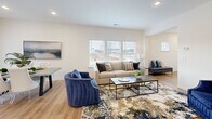 Located at 6295 Skipper Rd in Macon, Georgia, this two-story home offers a thoughtfully designed layout across two floors. The main level features an open-concept living, dining, and kitchen area bathed in natural light from multiple windows. The kitchen is a standout, showcasing crisp white shaker cabinets, granite countertops, a center island, and a full suite of stainless steel appliances, including a range, microwave, dishwasher, and refrigerator. Light hardwood flooring runs throughout the main level, adding warmth and continuity to the space. A staircase connects the main floor to the upper level, where three bedrooms are situated. The generously sized primary bedroom offers a comfortable retreat with natural light and hardwood floors. Three full bathrooms serve the home — one features a walk-in glass shower with granite vanity, while another includes a full soaking tub and shower combination. The attached garage provides convenient parking and additional storage space. Outside, a fenced backyard offers a private outdoor area. The home's clean, neutral palette and recessed lighting throughout create a bright, modern ambiance well-suited for everyday living.