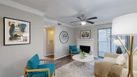 Located at 300 N Royal Oaks Blvd in Franklin, TN, this two-bedroom, two-bathroom single-floor residence offers a well-appointed layout designed for comfortable everyday living. The living room serves as the heart of the home, featuring a white brick fireplace, crown molding, a ceiling fan, and wood-style flooring. A sliding glass door opens to a private balcony, allowing natural light to fill the space and providing outdoor views. The galley-style kitchen is outfitted with white shaker cabinetry, quartz countertops, a subway tile backsplash, and stainless steel appliances including a range, microwave, refrigerator, and dishwasher. Both bedrooms are comfortably sized, each with ceiling fans and wood-style flooring. The primary bedroom offers a direct en-suite bathroom connection. The bathrooms feature white cabinetry, quartz countertops, and large vanity mirrors with modern fixtures. A dedicated laundry area houses an in-unit washer with overhead shelving for added storage. A hallway and closet round out the functional floorplan. Neutral gray tones and consistent finishes throughout give the home a cohesive, contemporary aesthetic.